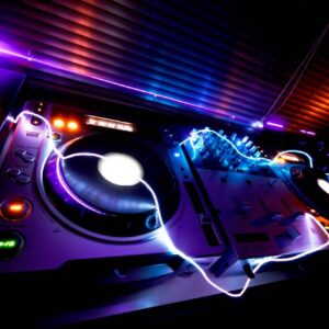 Neon-lit DJ turntables and mixer setup