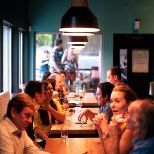 People chatting and drinking in busy restaurant
