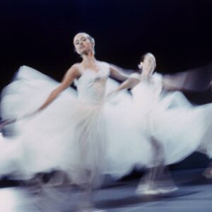 Motion-blurred ballerinas in white tutus
